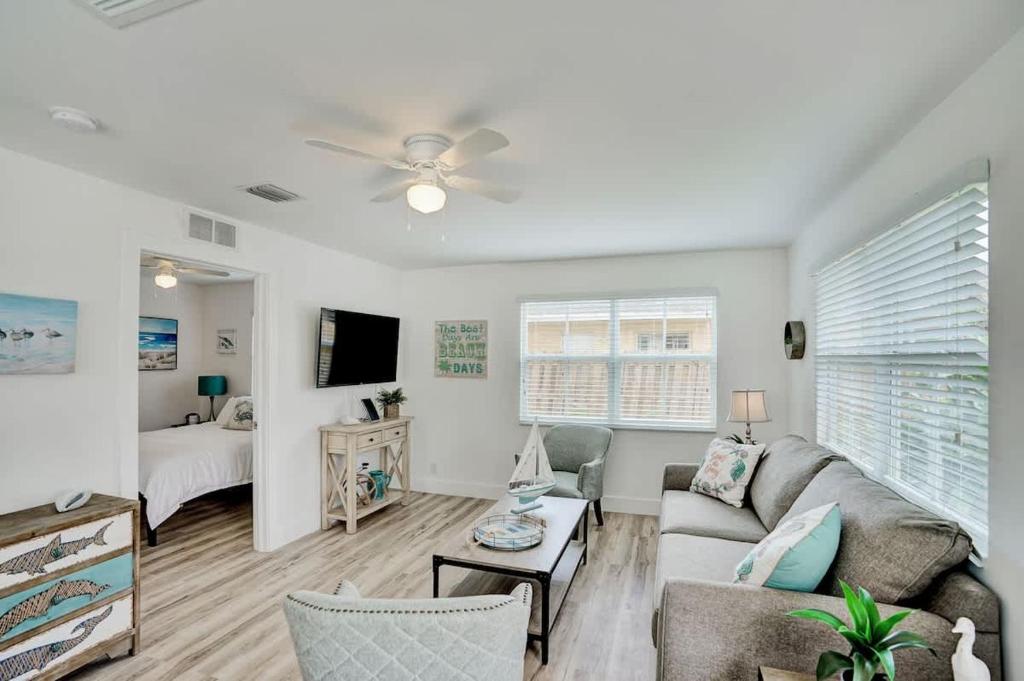 a living room with a couch and a ceiling fan at Beach Escape One Block from the Beach in Pompano Beach