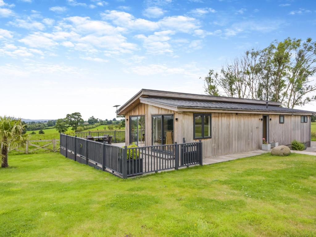 a small wooden house with a large yard at Whitehill Lodge - Uk47194 in Kirkcambeck