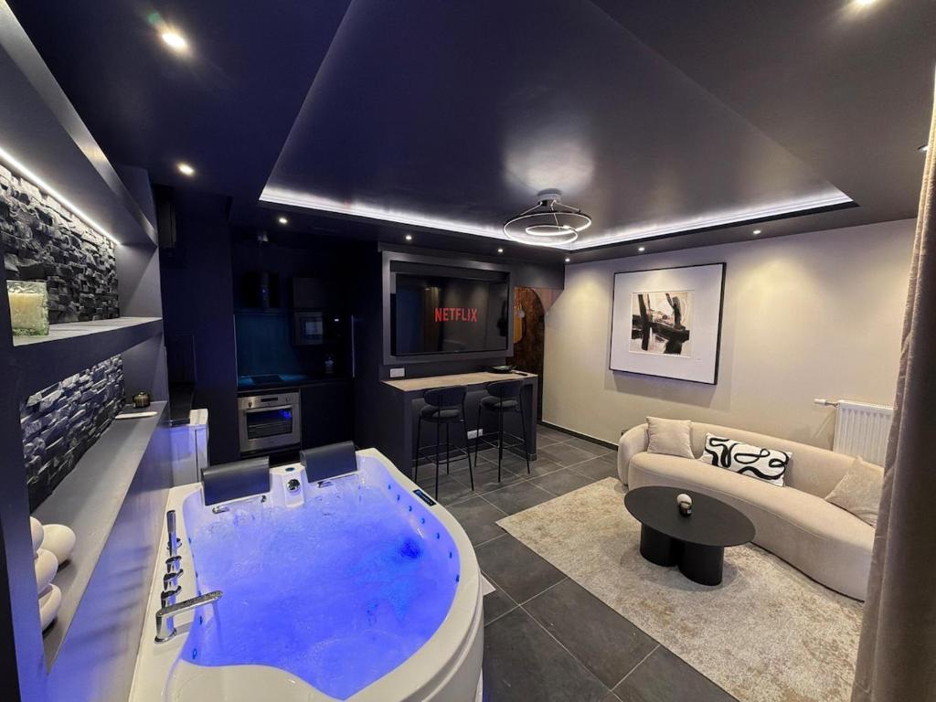 a living room with a large tub in the middle of a room at L'Écrin Beige - Immersive suite with private Jacuzzi in Champlan