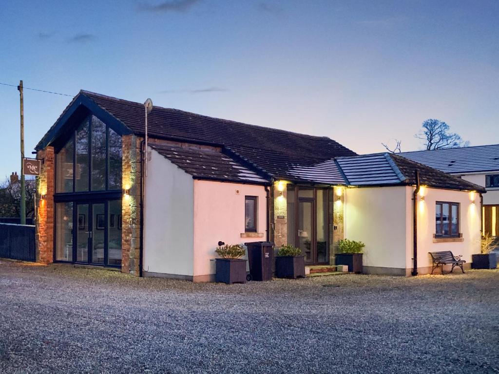 a house with lights on the side of it at Whitehill Barn - Uk47195 in Kirkcambeck