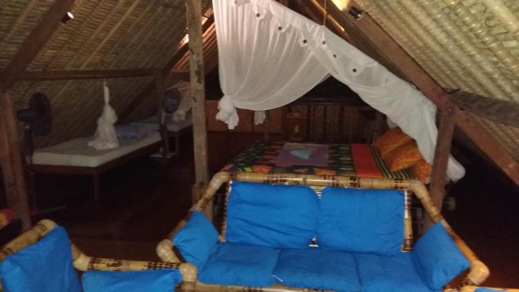 a room with a bed in a tent at Topi inn in Padangbai