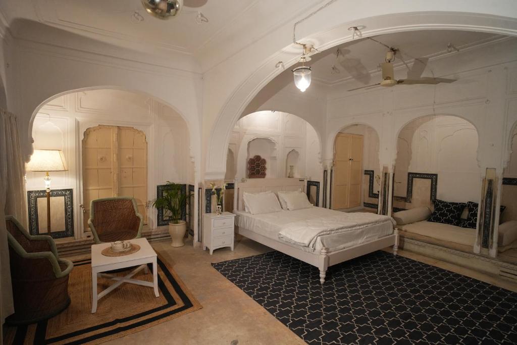 a large bedroom with a bed and a couch at Bagru Haveli in Jaipur
