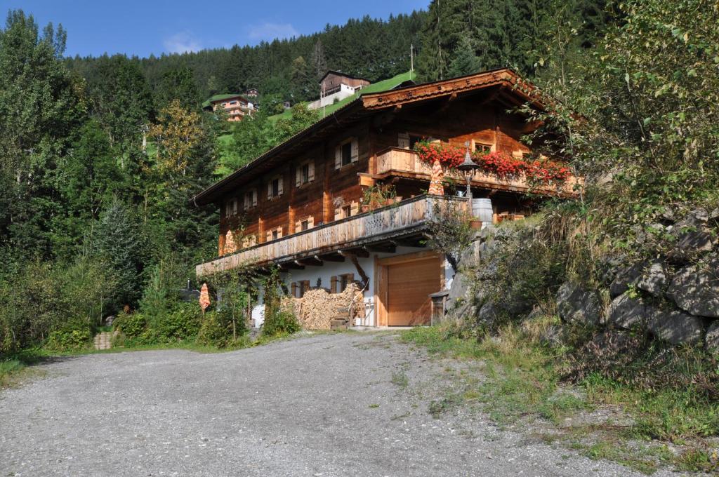 a house on a hill with a road in front of it at Sonnenplatzl im Zillertal in Ramsau im Zillertal