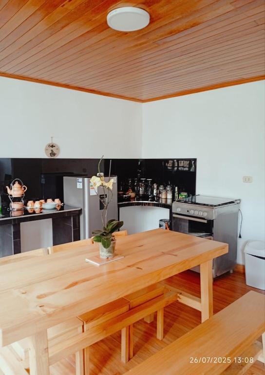 a kitchen with a wooden table in a kitchen at Casa de Campo in Chontabamba