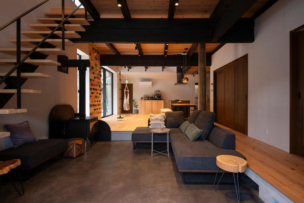 a living room with a couch and a table at ひのまきbase-暖- in Uda