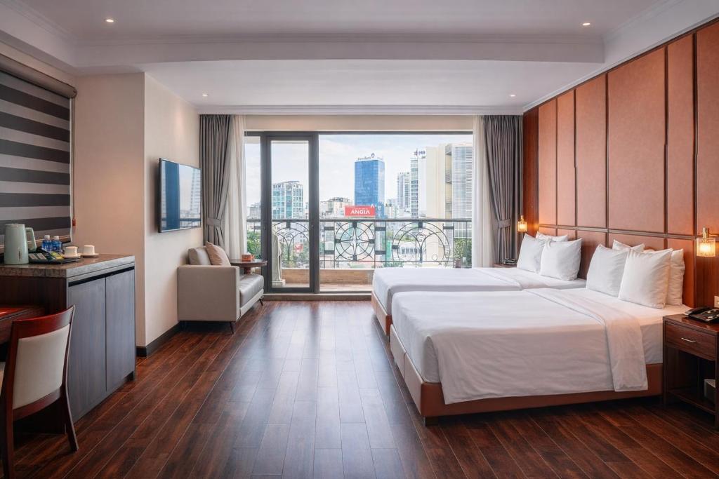 Postel nebo postele na pokoji v ubytování Bon Ami Hotel - Thiên Xuân Hotel