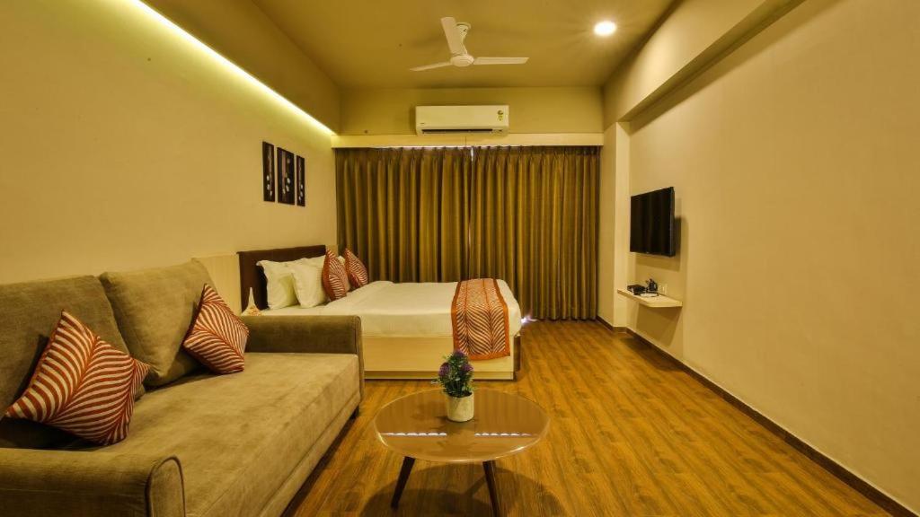 a living room with a couch and a bed at Magiical weekend in Surat