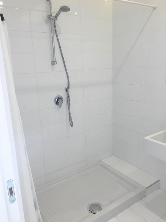 a white shower with a shower head in a bathroom at Casa Maria in Salerno