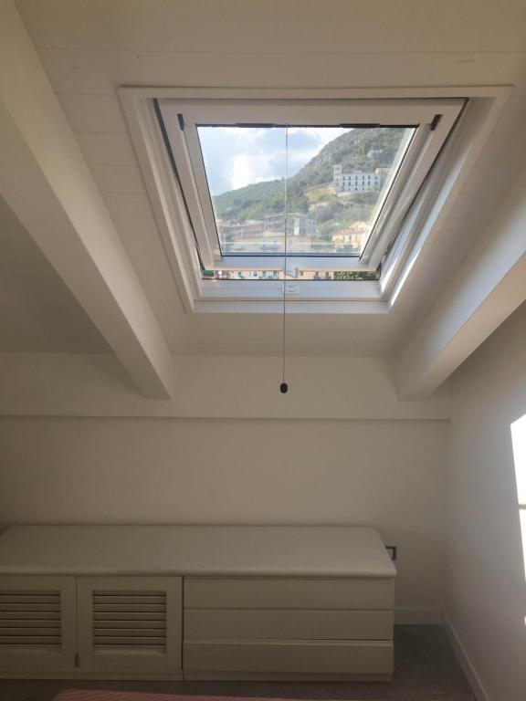 a bedroom with a skylight in the ceiling at Casa Maria in Salerno
