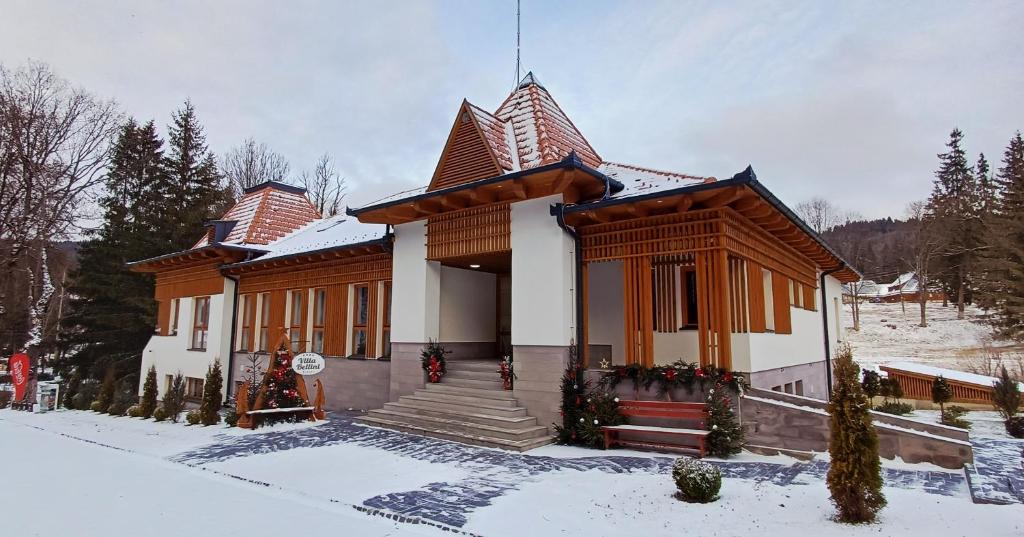 una piccola casa con neve per terra di Villa Bellini Borszék a Borsec