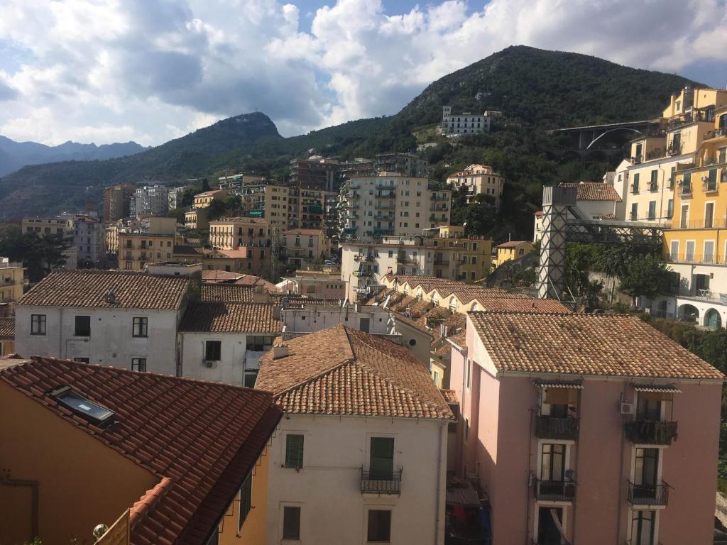 a view of a city with buildings and mountains at Casa Maria in Salerno