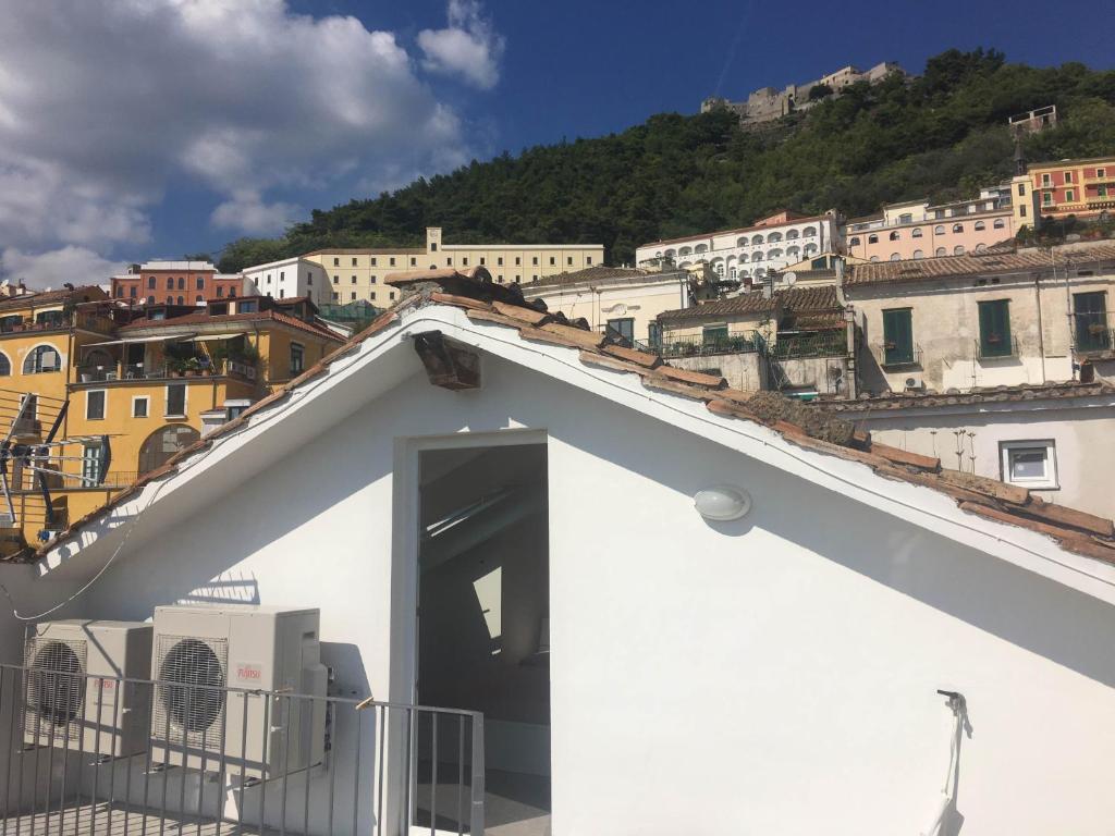 a white building with an open door on top of a city at Casa Maria in Salerno