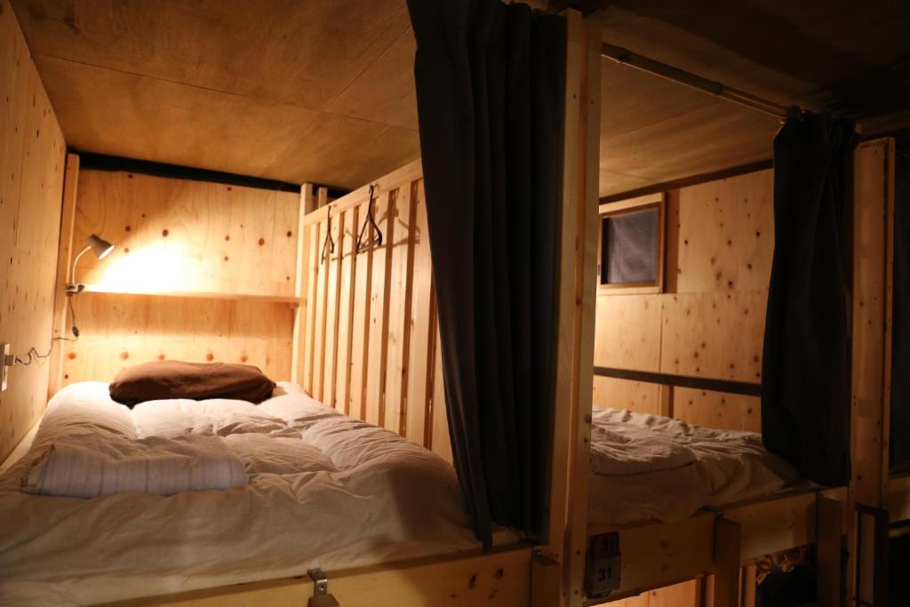Postel nebo postele na pokoji v ubytování Kagaribi Guesthouse