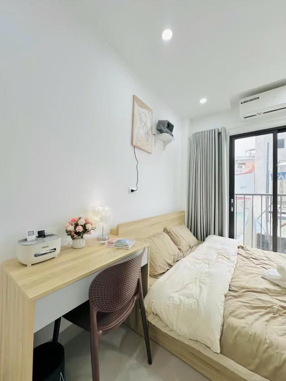 a bedroom with a desk with a bed and a desk at Cozy Homestay Tây Mỗ in Phú Thú