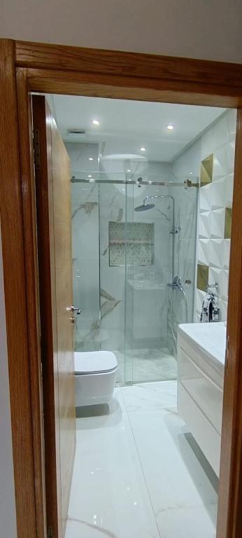 a bathroom with a shower and a toilet and a sink at Temara wifak in Temara