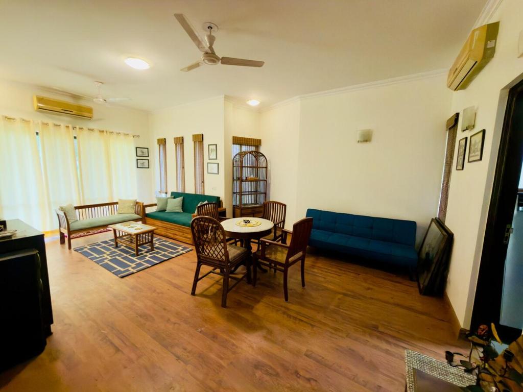 a living room with a couch and a table at Minimalist Escape in Gurgaon