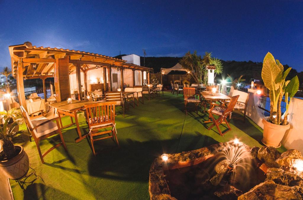 an outdoor patio with a table and chairs at night at Katerina apartments in Neos Pirgos