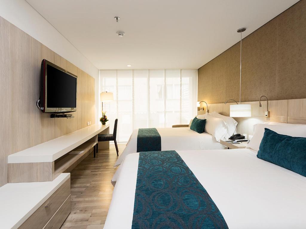 Postel nebo postele na pokoji v ubytování Hotel bh Bicentenario