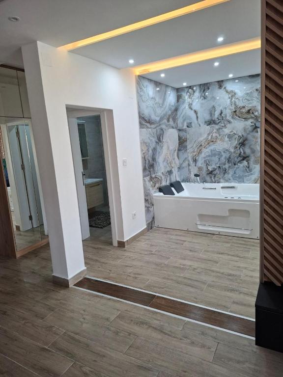a room with a large wall with a bath tub at Vidik jacuzzi apartment Divcibare in Divčibare