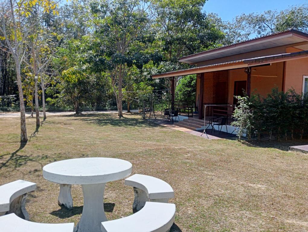 a white picnic table and benches in a park at Little Shark bungalow in Ban Bang Bao