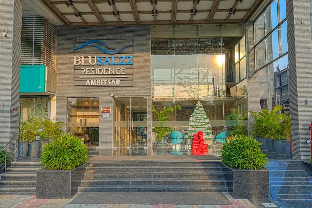 a building with a christmas tree in front of it at BluSalzz Residence Amritsar in Amritsar