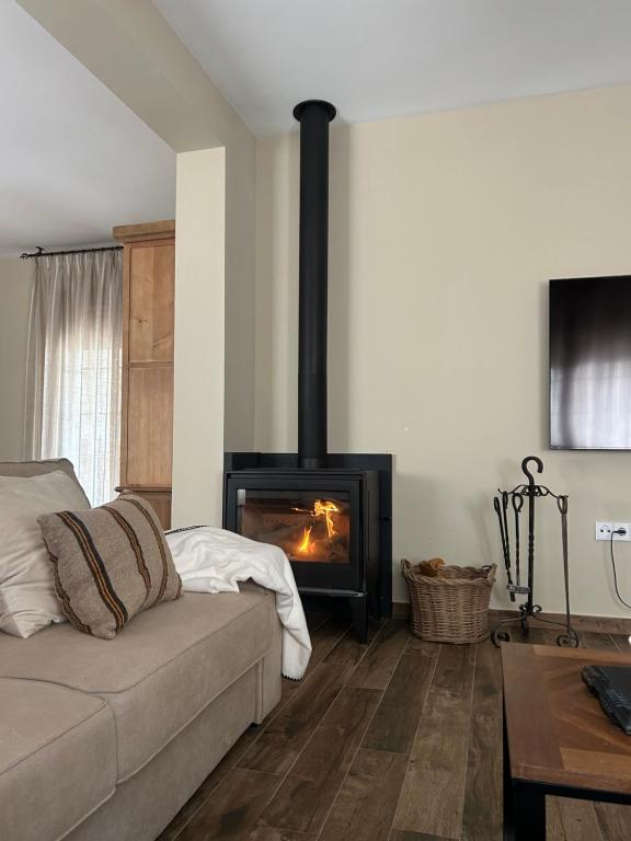 a living room with a couch and a fireplace at El Corral de Tía Gloria in Pepino