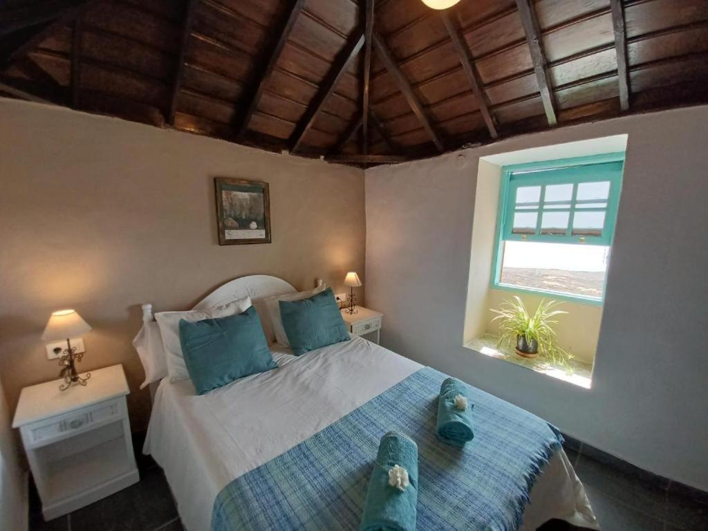 a bedroom with a bed with two teddy bears on it at El Olivo de Mazo 2 in Mazo