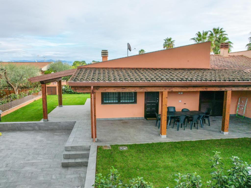 a house with a patio and a table at Villa Giuseppe Seaside in Lido Di Fondi