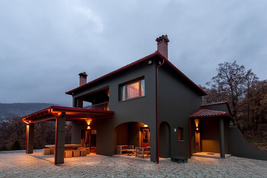 a black house with a ramp in front of it at K Ardamis Estate in Kastoria