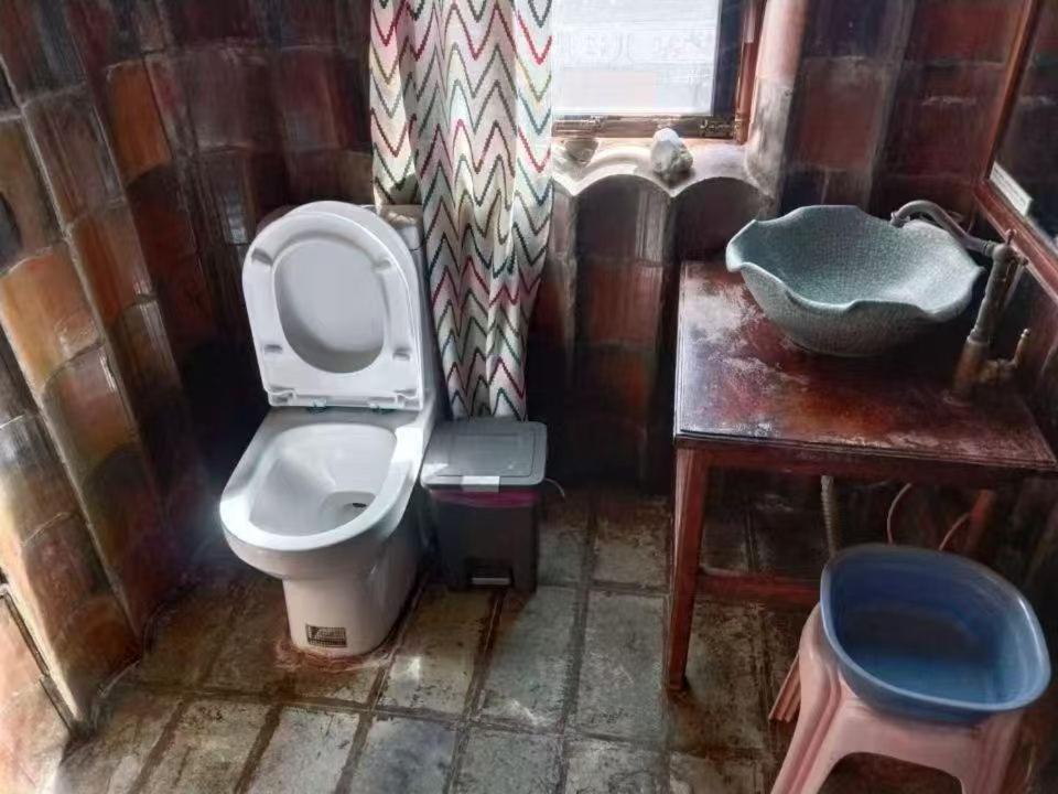 ein kleines Badezimmer mit Toilette und Waschbecken in der Unterkunft Dali Lily Guest House, close to the Honglongjing Gate of the ancient city,only 200 meters ,near the Cangshan and Erhai Lake,English-speaking service, convenient payment in Dali Ancient Town