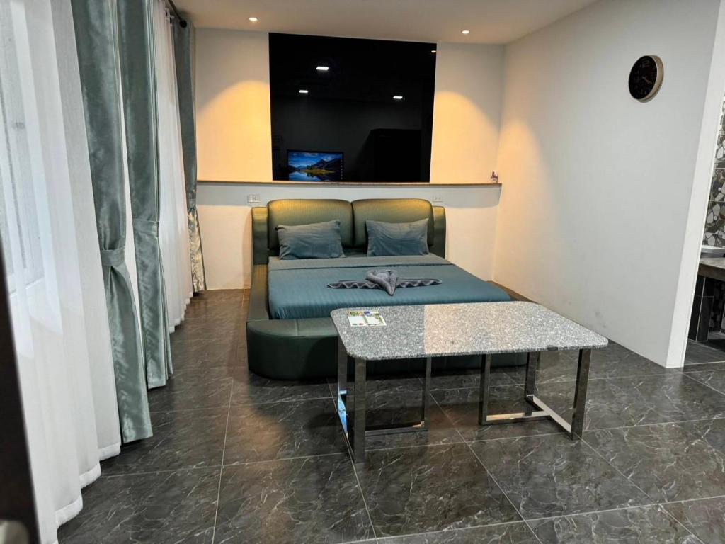 een bank in een kamer met een tafel en een bank sidx sidx sidx bij M-Resort Pathum-thani Thailand in Ban Khlong Sam Wa (3)