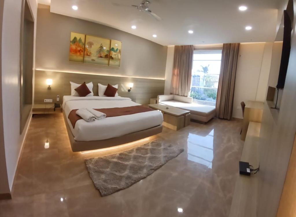 a large bedroom with a large bed and a window at The Riverside Inn in Vidisha