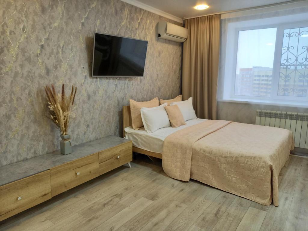 En eller flere senge i et værelse på Апартаменты в районе Космос