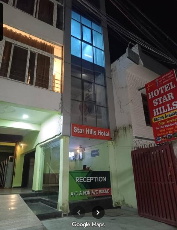 a building with a sign that reads star hits hospital at Star hill in Rishīkesh