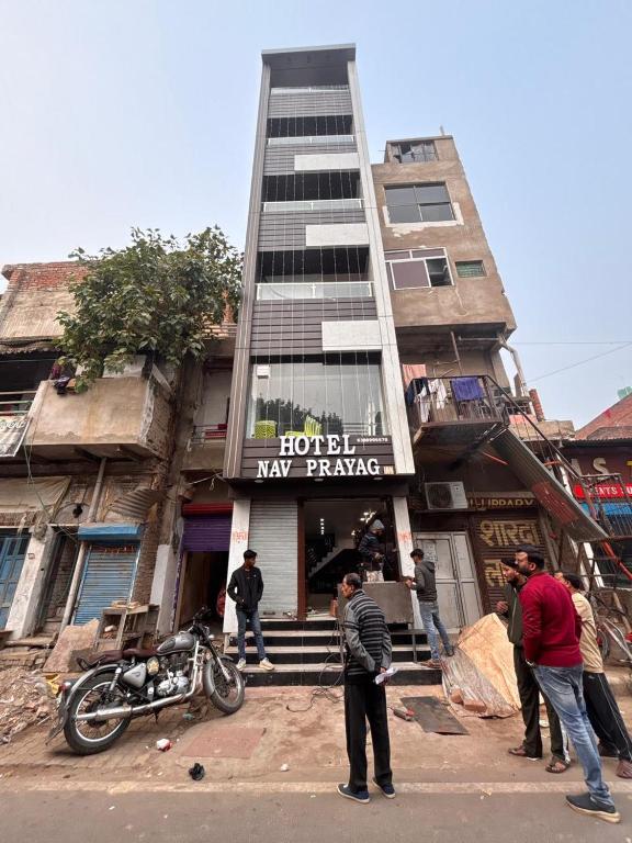 a group of people standing in front of a building at Hotel Nav Prayag Inn in Prayagraj