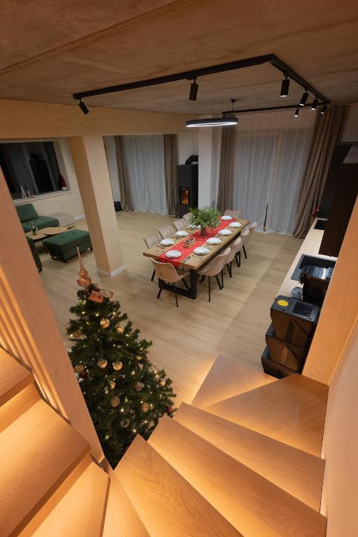 a room with tables and a christmas tree in the middle at Chalet Horizont in Ižipovce