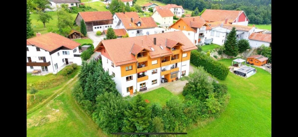 an aerial view of a large house on a green field at Hauser Hof Grübl in Waldkirchen