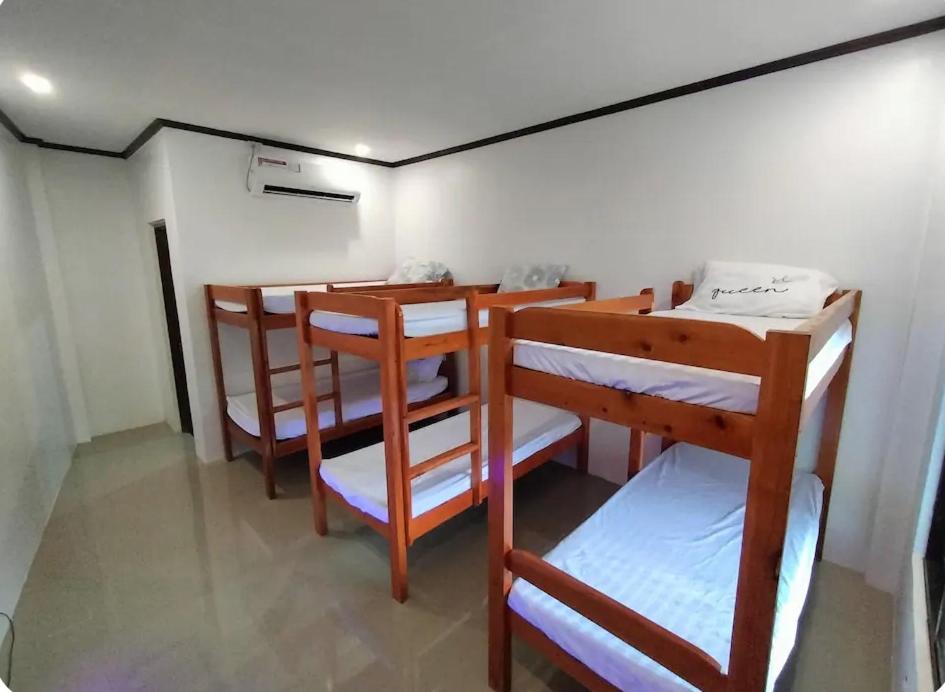 a group of bunk beds in a room at CocoVille Guesthouse Barkada Room in Alegria