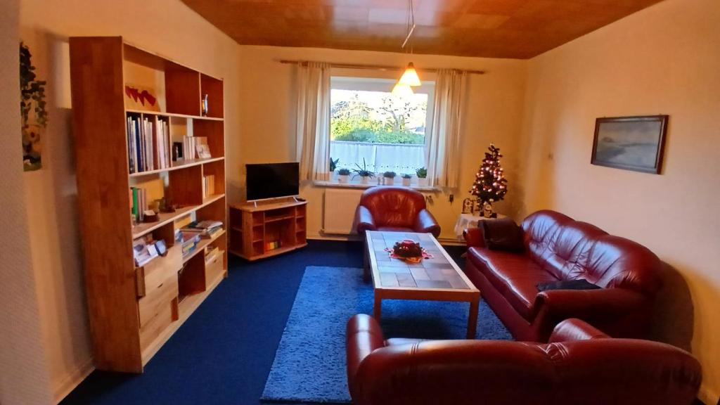 a living room with a couch and a table at Nordseeferienhaus Peter in Niebüll