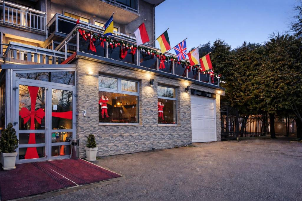 a building with flags on the side of it at Hotel Villa Harmony - Free Parking in Sarajevo