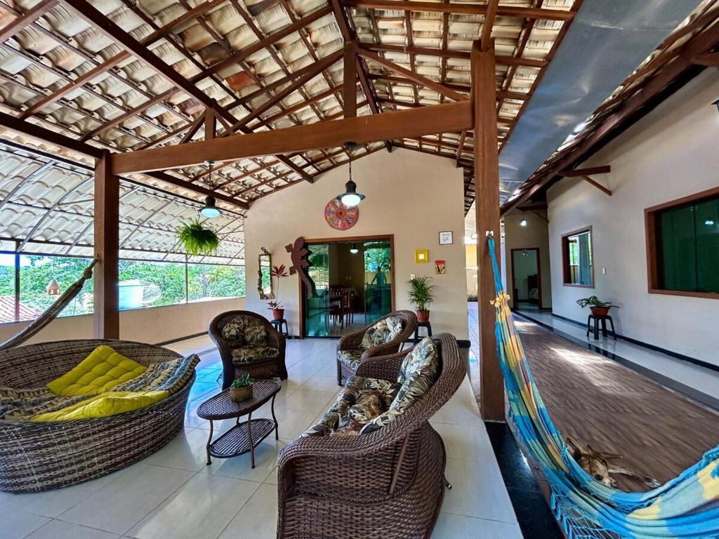 a room with couches and hammocks in a building at Casa do Cerrado in Santana do Riacho