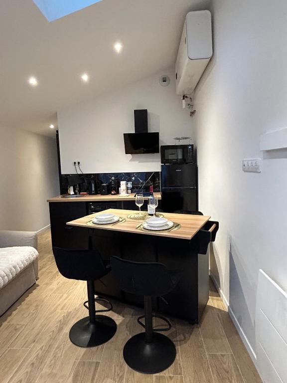 a kitchen with a island in the middle of a room at Solar Dream - close to Disney in Lagny