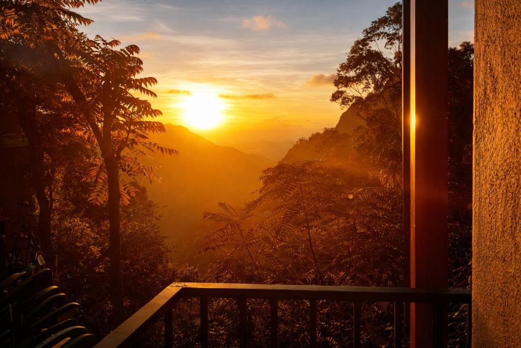 a view of the sunset from a window of a house at Amado Homestay Ella in Ella