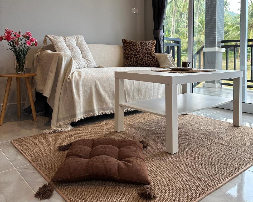 a living room with a couch and a table at Cozy Relax & Calm in Koh Phangan