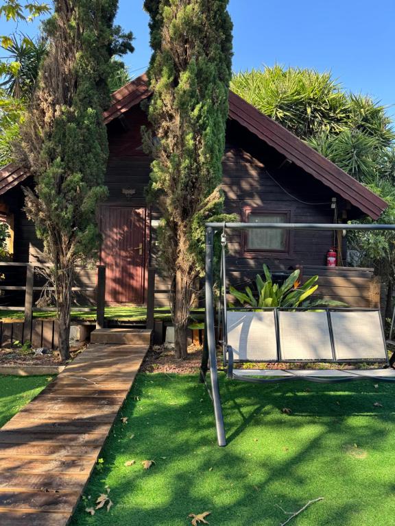 a house with a swing in the yard at לה בריזה - La Briza in Ma'alot Tarshiha