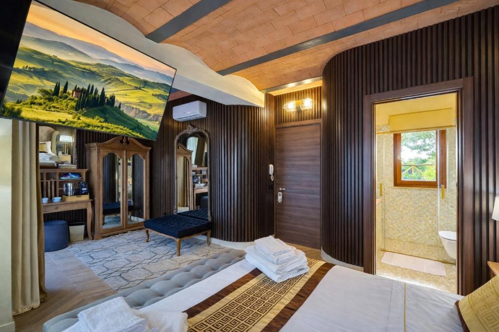 En eller flere senge i et værelse på Ermes Suite Collection