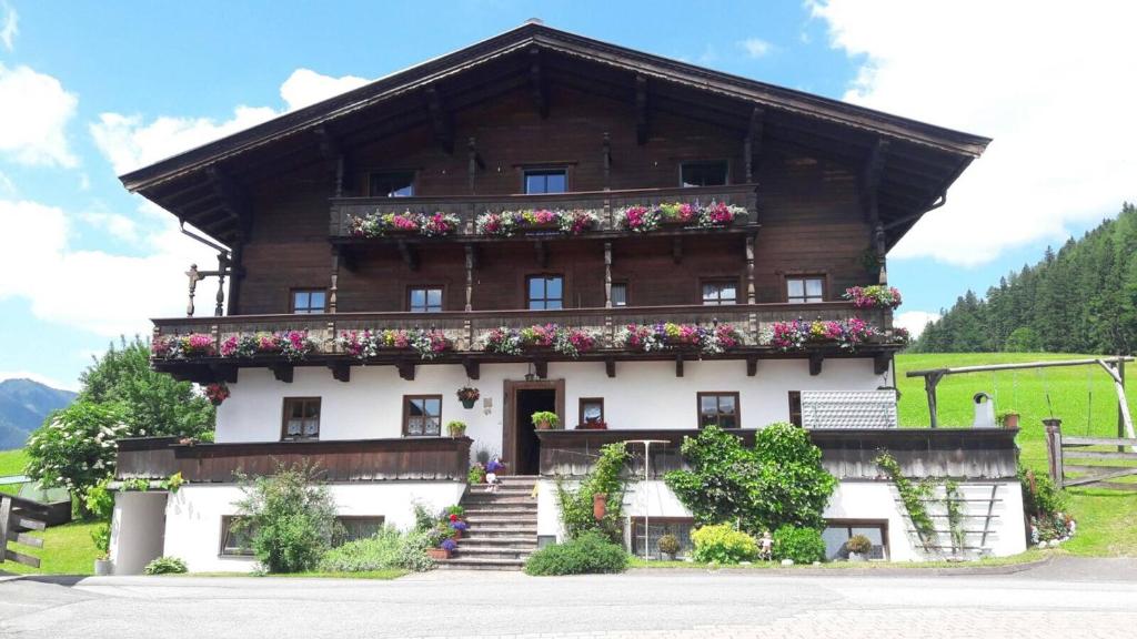 a building with flowers on the front of it at Badmeisterhof in Leogang