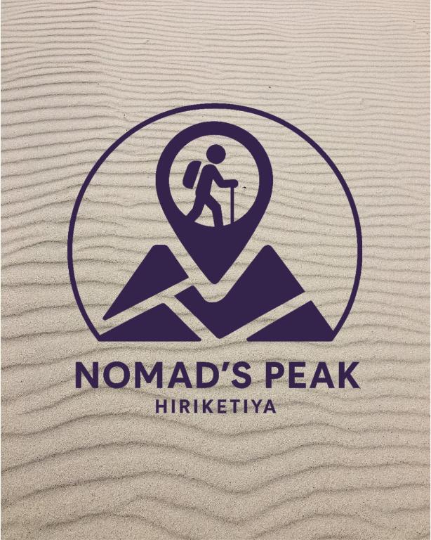a logo for nomads peak initiative with a man walking on a mountain at Nomad's Peak Hiriketiya in Dickwella