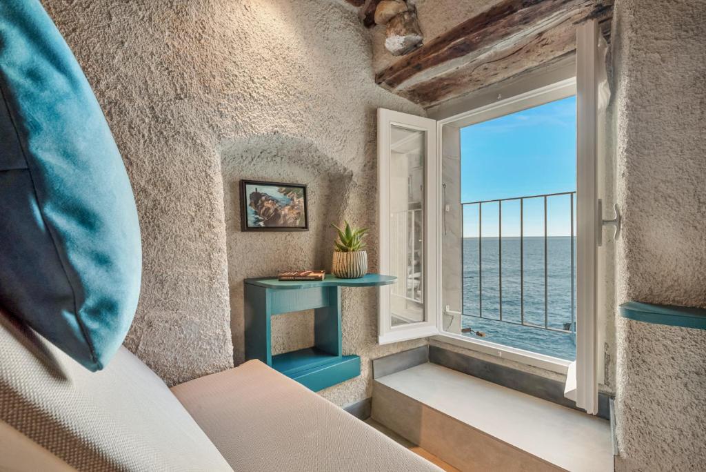 a room with a window with a view of the ocean at Marina Vista Apartment in Riomaggiore