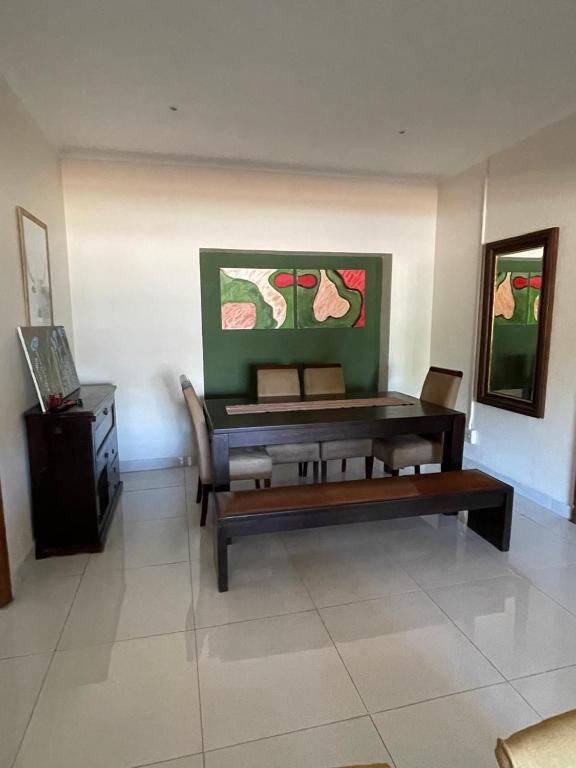 a living room with a table and a bench at Williston Bly of Gly in Williston